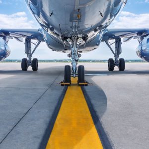 View of the underside of an aircraft on a runway.