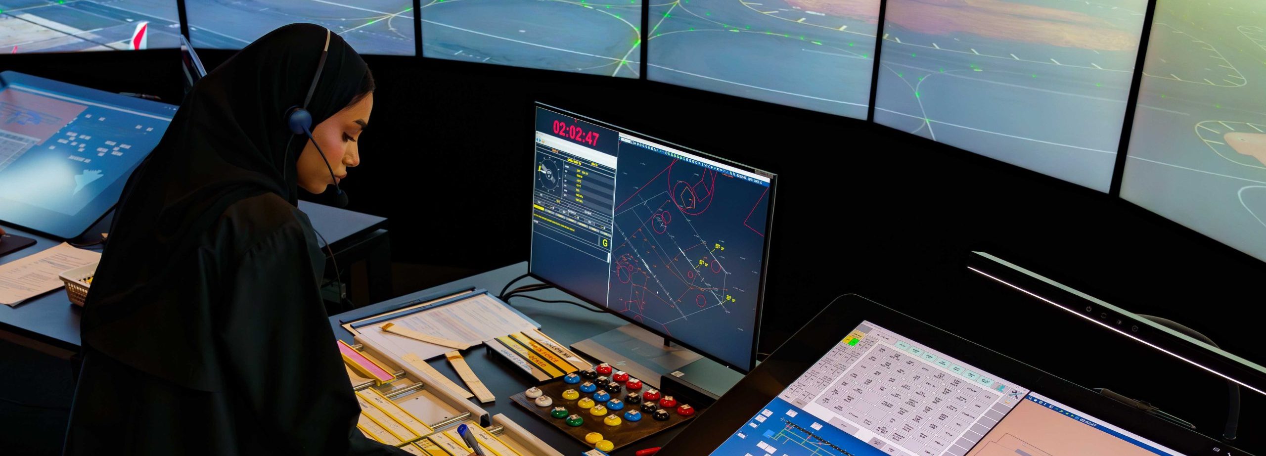 A women at a screen inside the air traffic control simulator.