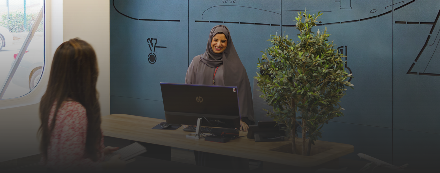 Woman at a reception desk at The Sharjah Training Centre for Airports Science